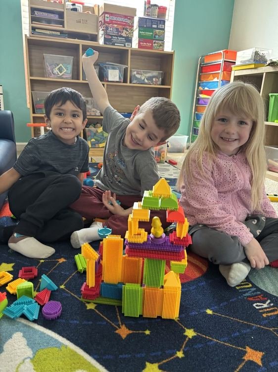 Children building a colorful tower together
