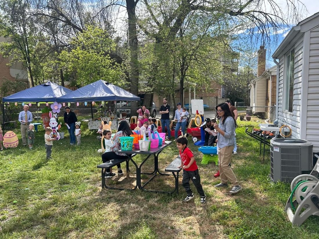 Families and children at an outdoor Easter egg hunt