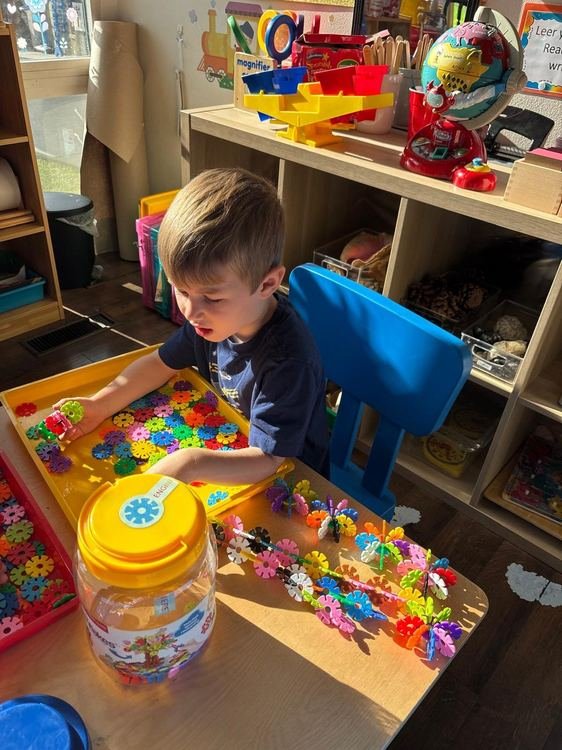 A boy playing with colorful connector toys