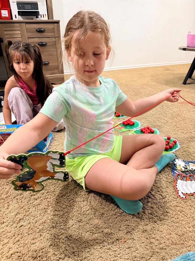 A child practicing hands-on fine motor skills