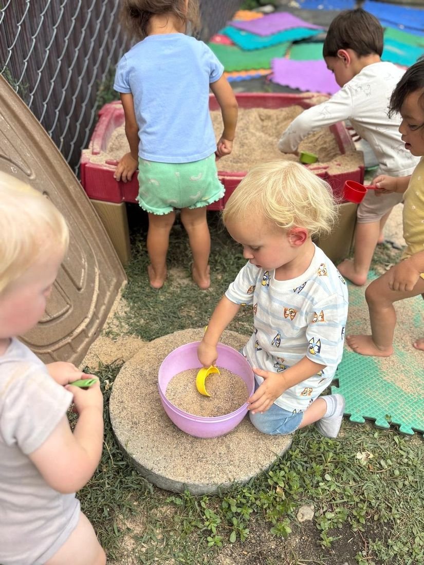 Children playing outdoors in the sandbox