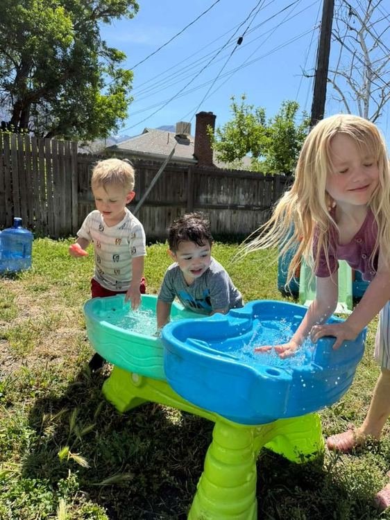 Children playing at the outdoor water table
