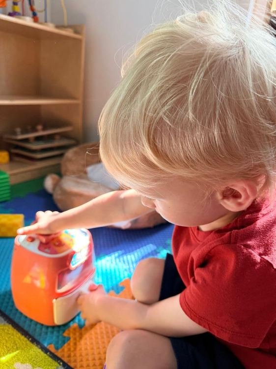 A toddler exploring a sensory toy