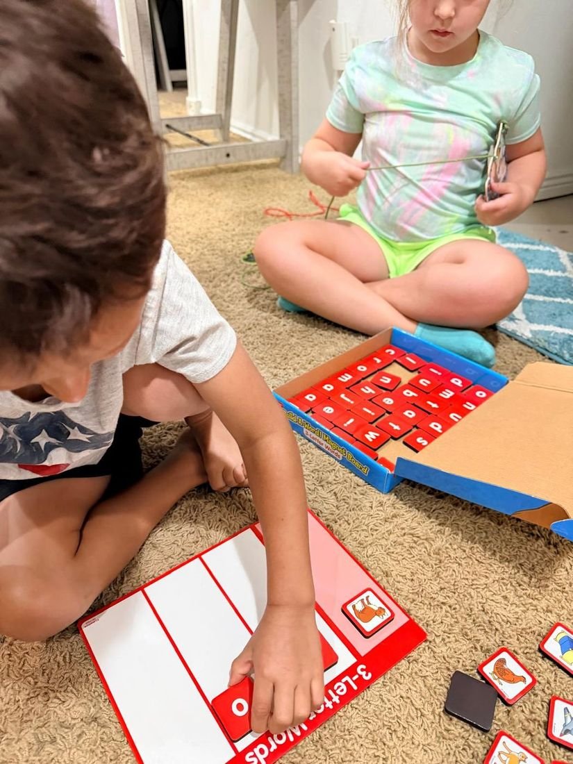 Children practicing letters with magnetic tiles